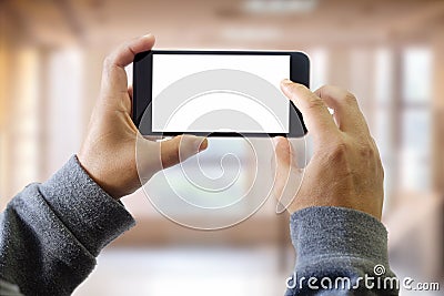 Man using smart phone on window with city building background Stock Photo