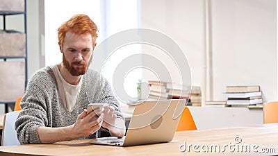 Man Using Smartphone, Browsing online at Work Stock Photo