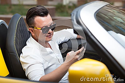 Man using smartphone in car Stock Photo