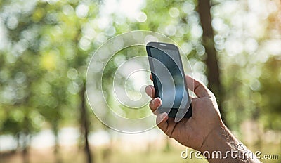 Man using smartphone in nature. Nature, Technology, Internet Stock Photo