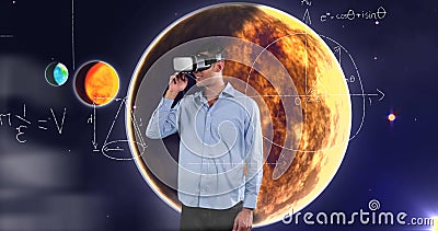 Man using VR headset exploring virtual planets and mathematical equations Stock Photo