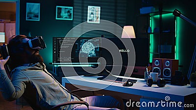 Man using VR headset to do programming scared after AI becoming sentient Stock Photo