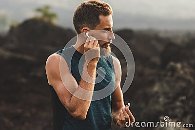 Man using wireless earphones air pods on running Stock Photo