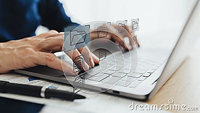 Man using or working on laptop with file management system. E-document digital data and information storage Stock Photo