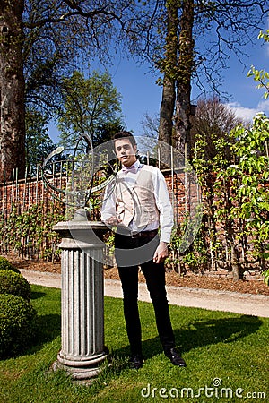 Man in Victorian clothing, pillar and sundial in t Stock Photo