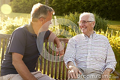 Man Visiting Senior Male Relative In Assisted Living Facility Stock Photo