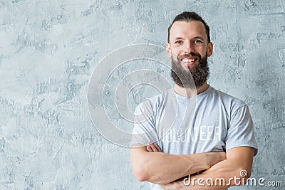 Man volunteer t-shirt smile participation altruism Stock Photo