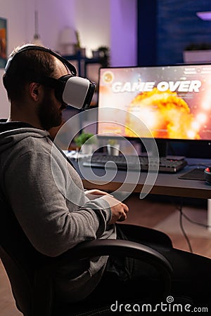 Man with vr glasses playing video games with joystick Stock Photo