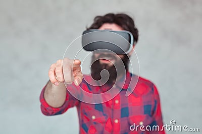 Man in VR glasses pointing at camera Stock Photo