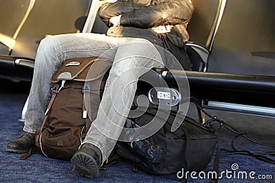 Man waiting airport terminal. Man sitting at chairs waiting lounge airport building Stock Photo