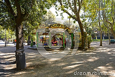 A man waits for his child at the Villa Borghese carousel in the Borghese Gardens of Rome, Itally Editorial Stock Photo