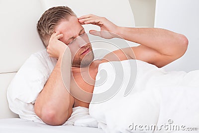 Man waking up with a nasty headache Stock Photo