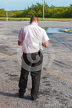 A man with a walkie-talkie at the airport, back view. Island of Editorial Stock Photo