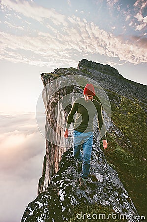 Man walking alone on the edge mountain ridge Stock Photo