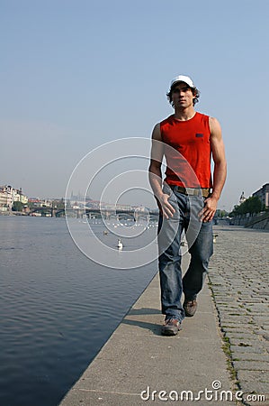 Man Walking Along the Embankment Stock Photo