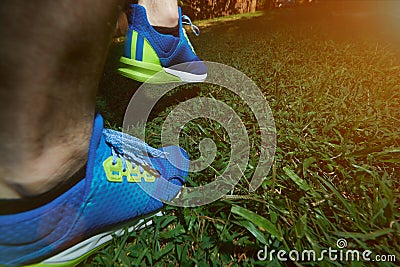 Man walking back on green grass Stock Photo