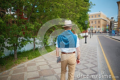 elegant man walking on a city street Stock Photo