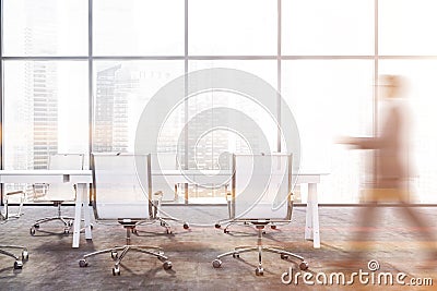 Man walking in panoramic meeting room Stock Photo