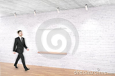 Man walking past built-in-wall seating Stock Photo