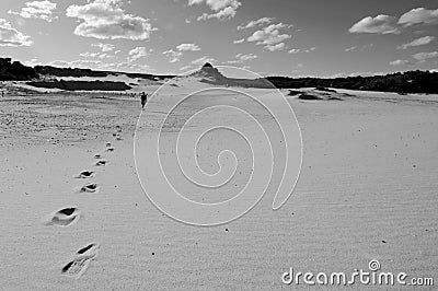 Man walks alone in desert Stock Photo