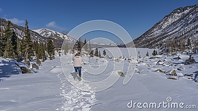 A man walks along a path trodden in the snow. Stock Photo