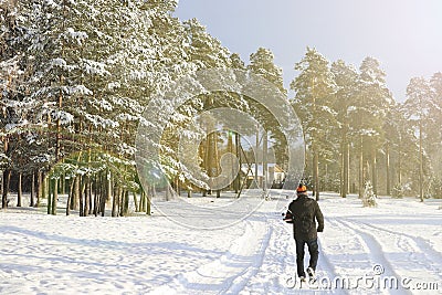 A man walks in the winter forest along a snowy path. The concept of a healthy lifestyle and outdoor activities Editorial Stock Photo