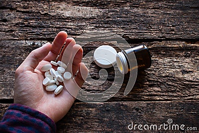 Man wants to commit suicide by eating pills Stock Photo