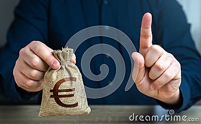 A man warns with his finger offering a euro money bag. Bad credit history. Stock Photo