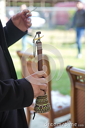 The man was holding a zurna in his hand . A man playing zurna traditional instrument in wedding Stock Photo