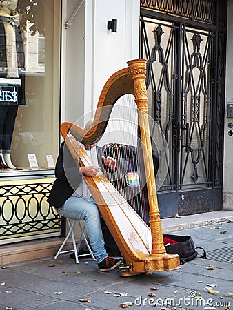 The man was playing Harp at street in Paris. Editorial Stock Photo