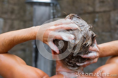 Man washing hair with shampoo Stock Photo