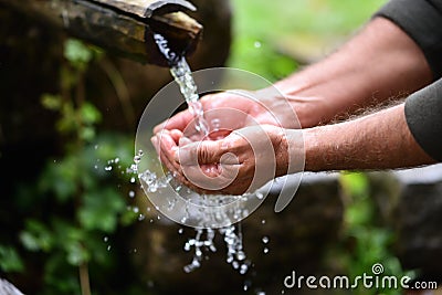 Man washing hands in fresh, cold, potable water Stock Photo