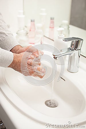Man washing hands with soap at home. coronavirus prevention hand hygiene Stock Photo