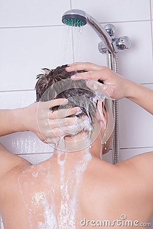 Man washing his hair in shower