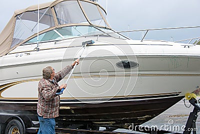 Man washing power boat Stock Photo