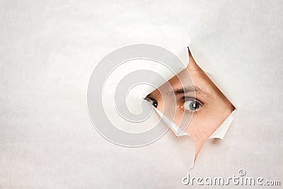 Man watches through a hole Stock Photo