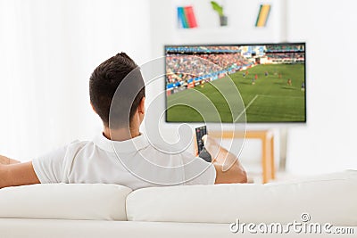 Man watching football or soccer game on tv at home Stock Photo