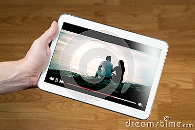 Man watching movie online with mobile device Stock Photo