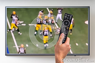 Man is watching rugby match on TV Editorial Stock Photo