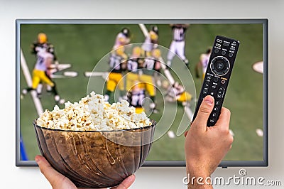 Man is watching rugby match on TV Editorial Stock Photo