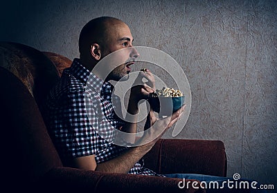 Man watching tv at night. Stock Photo