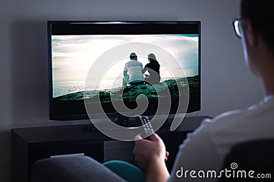 Man watching tv or streaming movie or series with smart tv Stock Photo