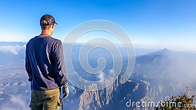 A man watching the volcanic landscape in front of him Stock Photo