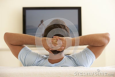 Man Watching Widescreen TV At Home Stock Photo