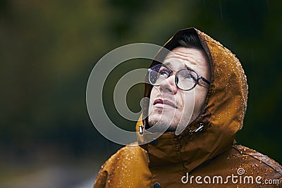 Man in waterproof jacket during rain Stock Photo