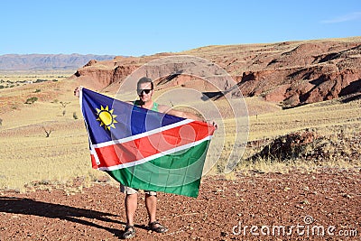 Man waving the flag of Namibia Editorial Stock Photo