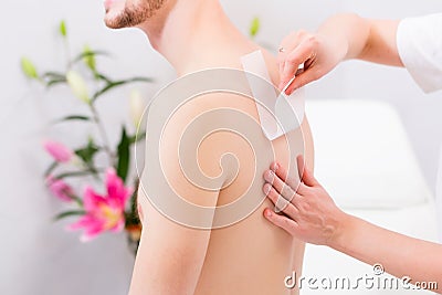 Man at waxing hair removal in beauty parlor Stock Photo