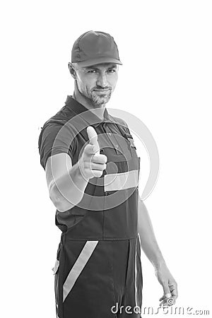 Man wear working overall. handsome worker in uniform. building engineer pointing finger. mature skilled laborer in cap Stock Photo