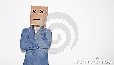 Man wearing a brown paper bag over his head with a weird face expression Stock Photo