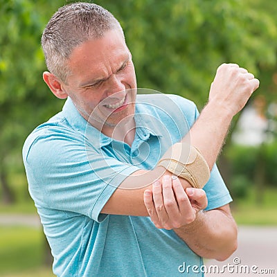 Man wearing elbow brace Stock Photo